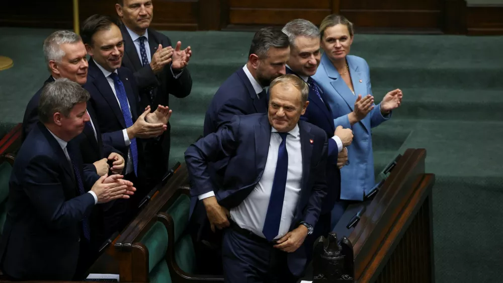 Polish Minister of Foreign Affairs Radoslaw Sikorski, Deputy Prime Minister and Minister of National Defence Wladyslaw Kosiniak-Kamysz, Minister of Education Barbara Nowacka and Prime Minister Donald Tusk react after a vote of confidence for Tusk's center-left coalition government, in Warsaw, Poland, June 11, 2025. REUTERS/Kacper Pempel
