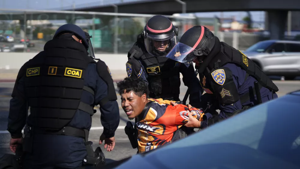 A protester is arrested by California Highway Patrol near the federal building in downtown Los Angeles on Tuesday, June 10, 2025. (AP Photo/Eric Thayer)