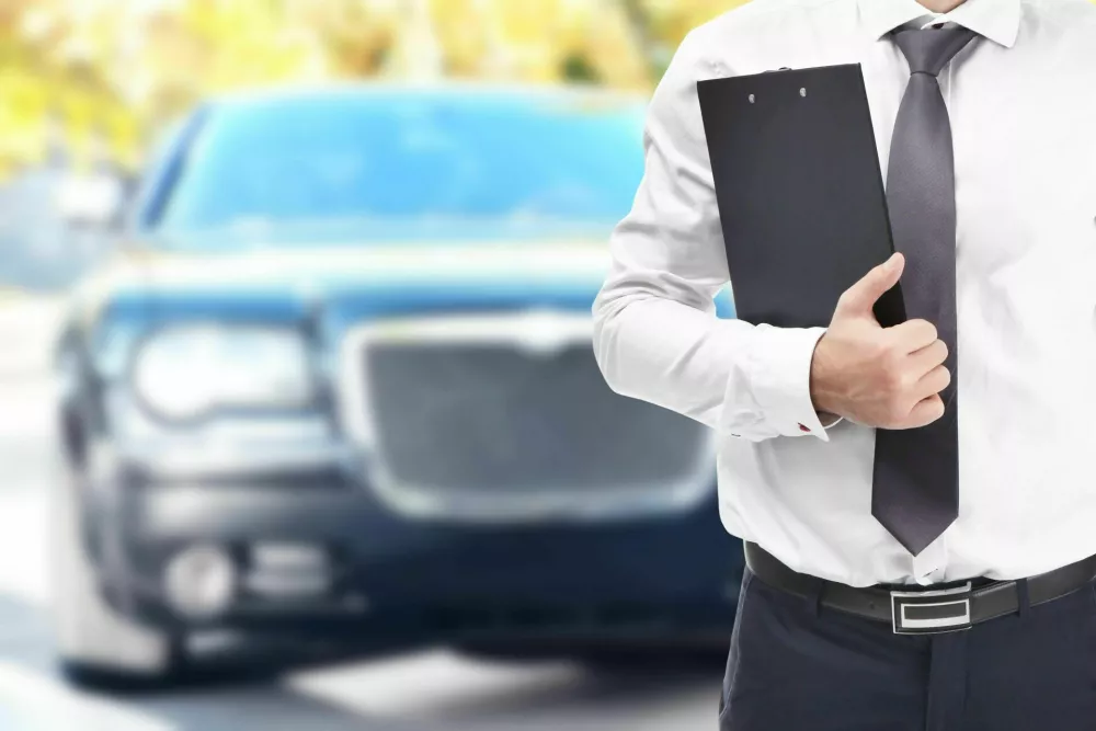 2BFPPNW Insurance agent with clipboard and car on background