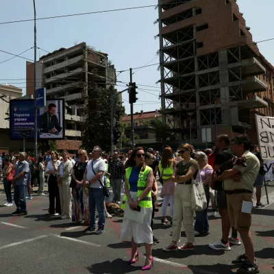 University students and other people stand in silence to commemorate the 16 victims, who were killed after a railway concrete canopy fell in November 2024 in Novi Sad, during a protest against government pressure on the universities, in front of a government building, in Belgrade, Serbia, June 9, 2025. REUTERS/Zorana Jevtic