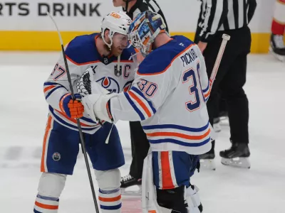 Jun 12, 2025; Sunrise, Florida, USA; Edmonton Oilers center Connor McDavid (97) celebrates with goaltender Calvin Pickard (30) after the win in overtime against the Florida Panthers in game four of the 2025 Stanley Cup Final at Amerant Bank Arena. Mandatory Credit: Sam Navarro-Imagn Images