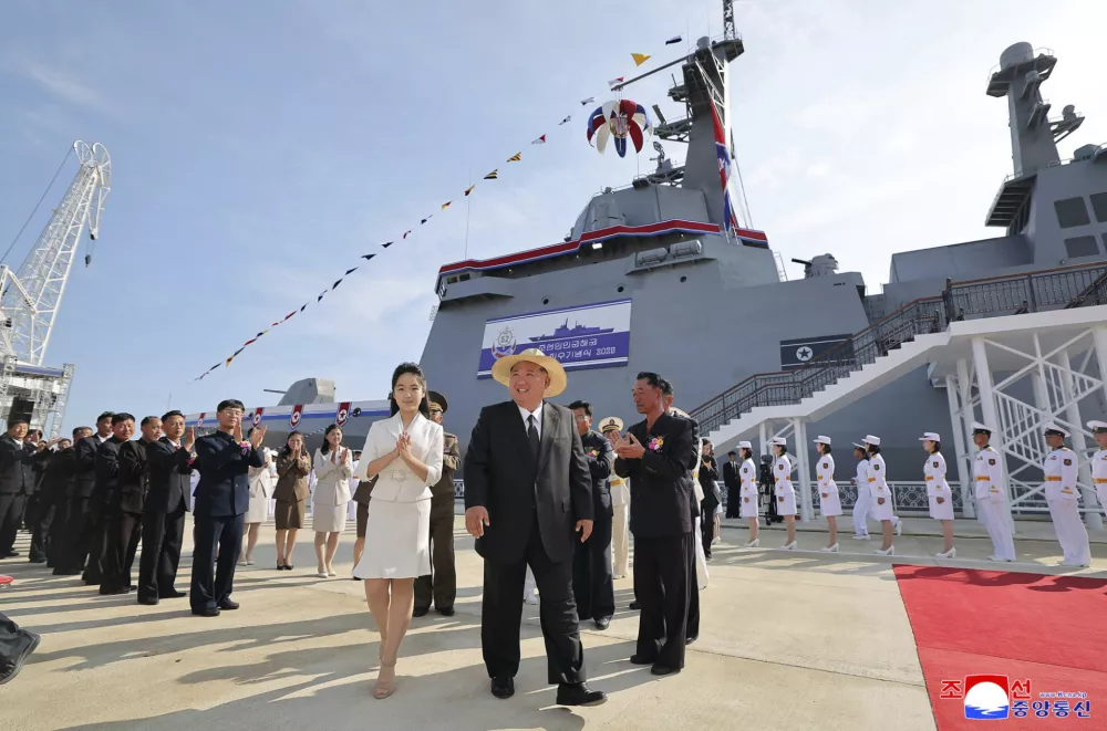In this photo provided by the North Korean government, its leader Kim Jong Un, center, and his daughter attend a launch ceremony of a destroyer named Kang Kon at the Rajin shipyard in Rason, North Korea, Thursday, June 12, 2025. Independent journalists were not given access to cover the event depicted in this image distributed by the North Korean government. The content of this image is as provided and cannot be independently verified. Korean language watermark on image as provided by source reads: "KCNA" which is the abbreviation for Korean Central News Agency. (Korean Central News Agency/Korea News Service via AP)
