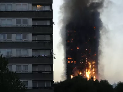 FILE - In this Wednesday, June 14, 2017 file photo smoke and flames rise from the Grenfell Tower high-rise building in west London. (AP Photo/Matt Dunham, File)
