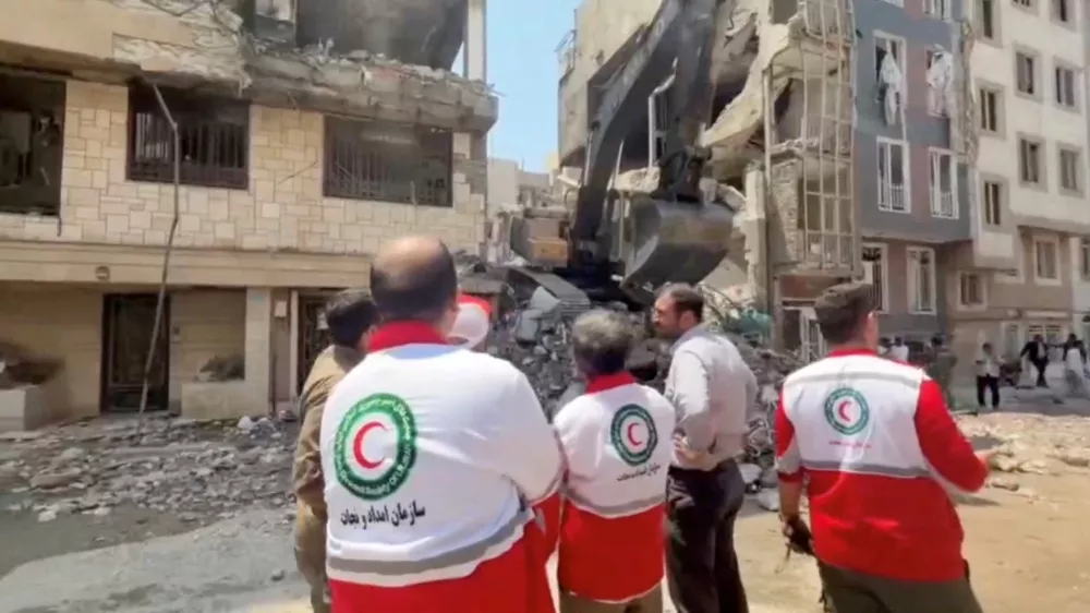Rescuers work at the site of a damaged building, in the aftermath of Israeli strikes, in location given as Tehran, Iran, in this screen grab from a handout video released on June 14, 2025. Iranian Red Crescent Society/Handout via REUTERS ATTENTION EDITORS - THIS PICTURE WAS PROVIDED BY A THIRD PARTY. NO RESALES. NO ARCHIVES. MANDATORY CREDIT