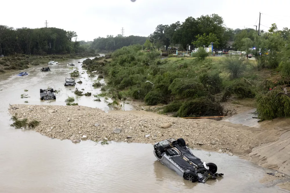 Multiple damaged cars are seen in flood waters Thursday, June 12, 2025, after heavy rains overnight in San Antonio. (Jessica Phelps/The San Antonio Express-News via AP)