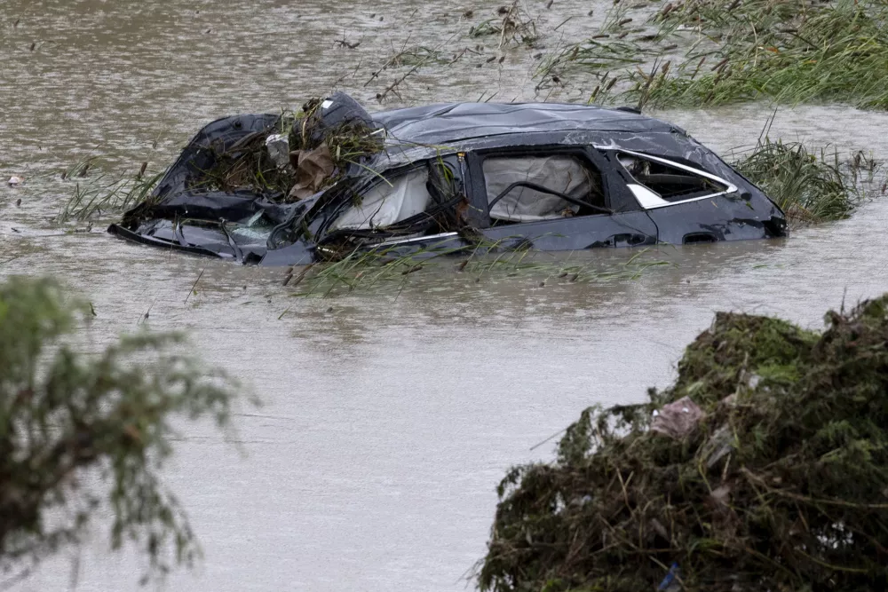 A damaged car is seen in flood waters Thursday, June 12, 2025, after heavy rains overnight in San Antonio. (Jessica Phelps/The San Antonio Express-News via AP)