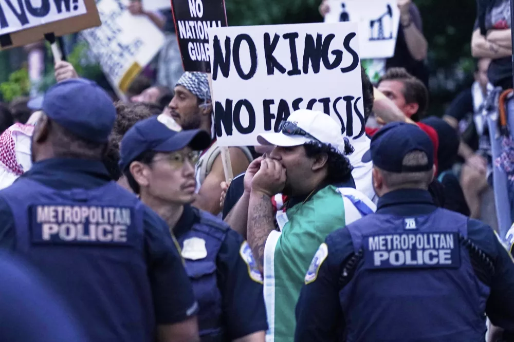 Demonstrators are blocked by police during a demonstration against President Donald Trump policies in Washington, Saturday, June 14, 2025. (AP Photo/Jose Luis Magana)