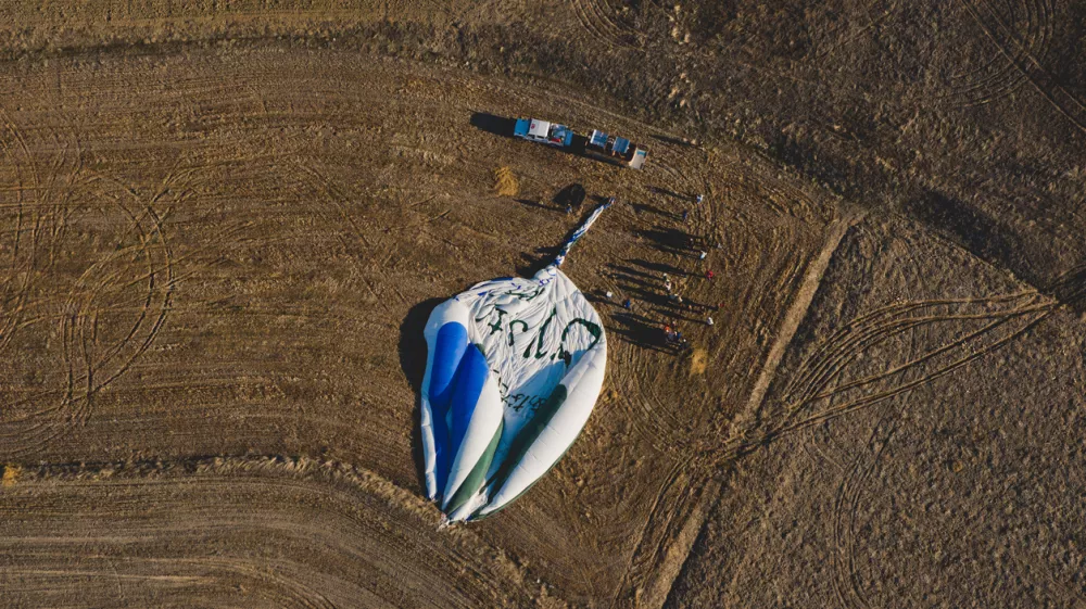 Goreme, Turkey - April 4, 2012: Hot air balloons for tourists flying over rock formations at sunrise in the valley of Cappadocia.
