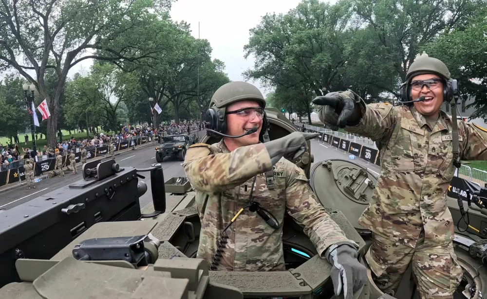 First Lieutenant Zachary Buher and Staff Sergeant Cesar Lua, members of the U.S. Army's Charlie Company, 2nd Battalion, 5th Cavalry Regiment, 1st Armored Brigade Combat Team, 1st Cavalry Division operate a M1A2 SEP V3 tank during the Army's 250th Birthday parade in Washington, D.C., U.S., June 14, 2025. REUTERS/Brian Snyder