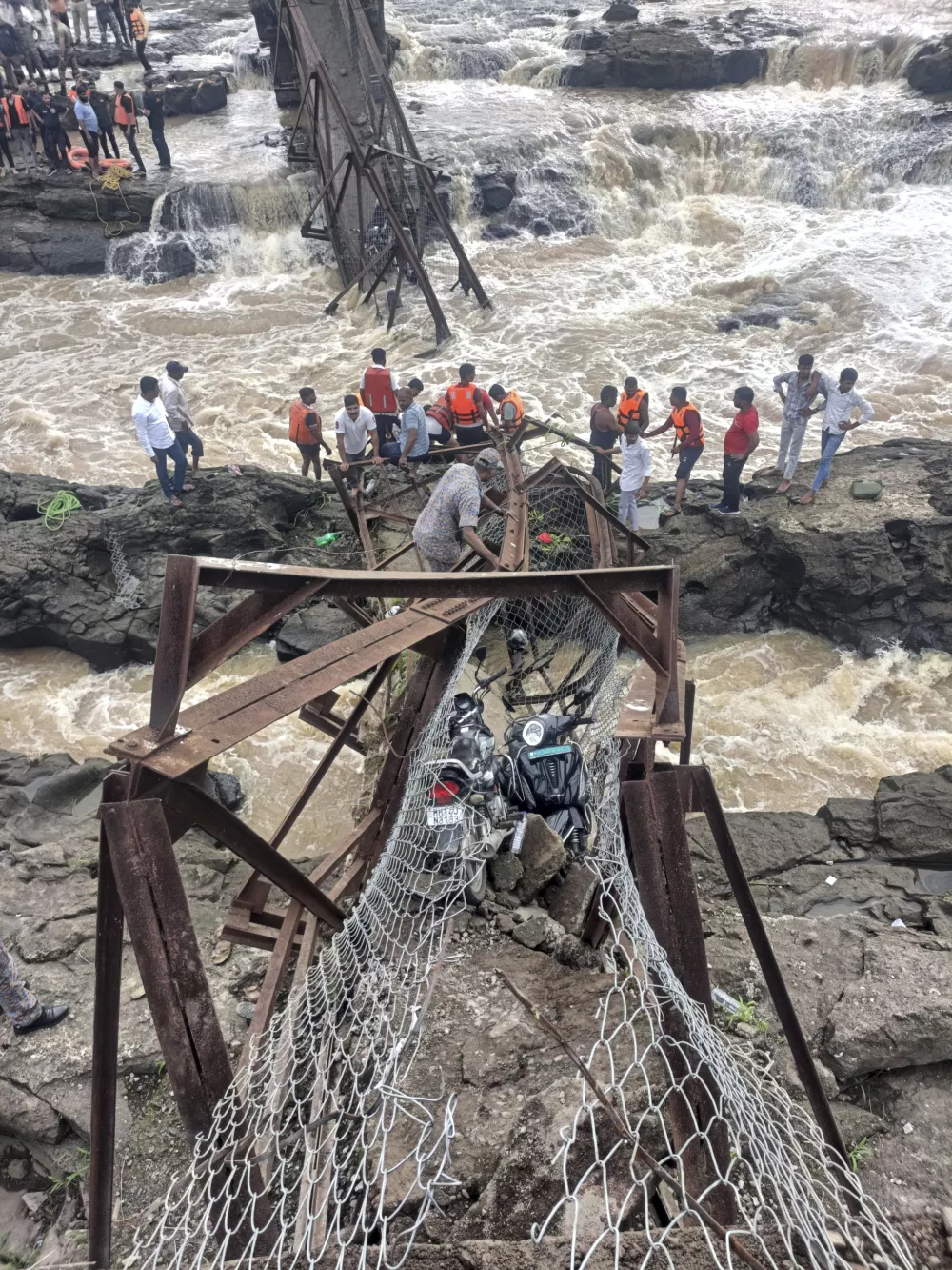 Rescuers work at the site of a bridge collapse near Pune, India, Sunday, June 15, 2025. (AP Photo)