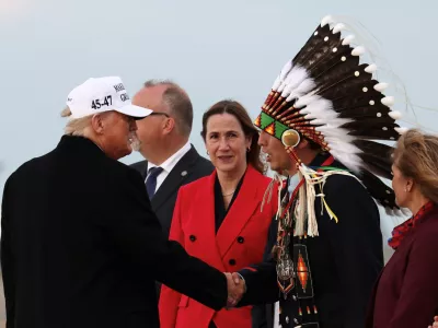 U.S. President Donald Trump and Tsuut'ina Minor Chief Steven Crowchild, Treaty 7 Representative, shake hands upon Trump's arrival to attend the G7 Leaders' Summit in the Rocky Mountain resort town of Kananaskis, at Calgary International Airport in Calgary, Alberta, Canada, June 15, 2025. REUTERS/Kevin Lamarque