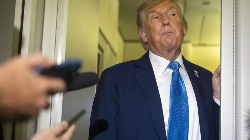 President Donald Trump speaks with reporters while flying aboard Air Force One en route from Calgary, Canada to Joint Base Andrews, Md., late Monday, June 16, 2025. (AP Photo/Mark Schiefelbein)