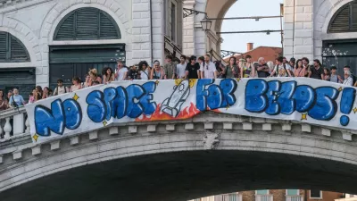 Protesters display a banner reading "No Space for Bezos!" on the Rialto Bridge during a protest against Amazon founder Jeff Bezos' upcoming wedding to Lauren Sanchez being held in Venice, Italy, June 13, 2025. REUTERS/Manuel Silvestri
