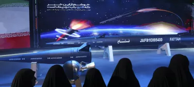 FILE - Women look at Fattah missile in a ceremony in Tehran, Iran, Tuesday, June 6, 2023. (Hossein Zohrevand/Tasnim News Agency via AP, File)