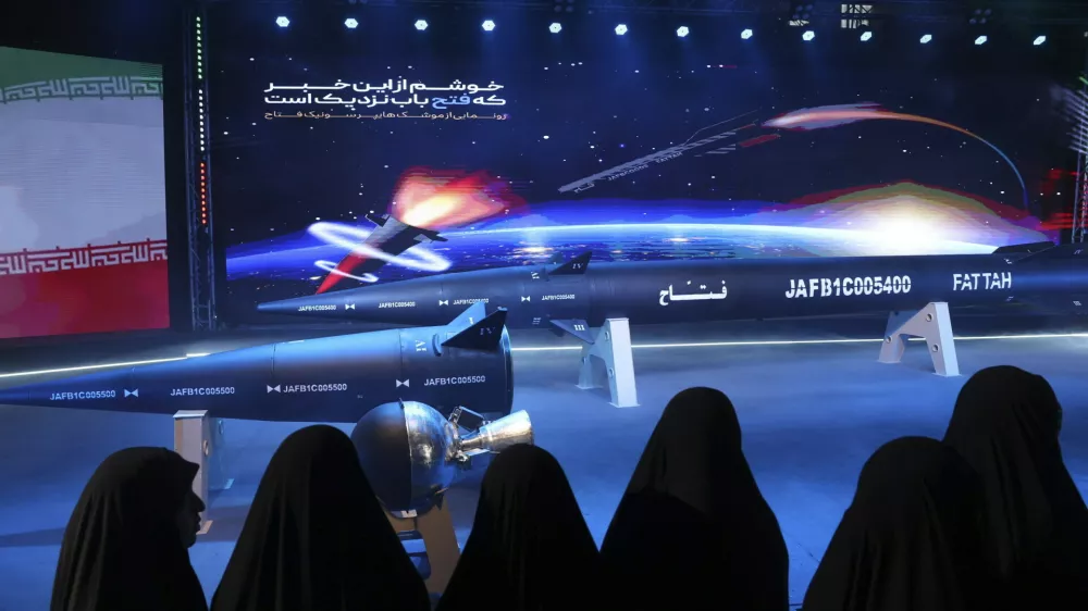 FILE - Women look at Fattah missile in a ceremony in Tehran, Iran, Tuesday, June 6, 2023. (Hossein Zohrevand/Tasnim News Agency via AP, File)
