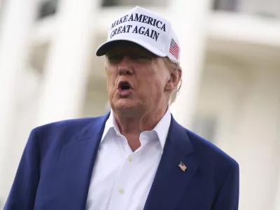President Donald Trump talks with reporters before a flag pole is installed on the South Lawn of the White House, Wednesday, June 18, 2025, in Washington. (AP Photo/Evan Vucci)