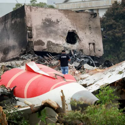 FILE PHOTO: FILE PHOTO: A fire officer stands next to the crashed Air India Boeing 787-8 Dreamliner aircraft, in Ahmedabad, India, June 13, 2025. REUTERS/Adnan Abidi/File Photo/File Photo