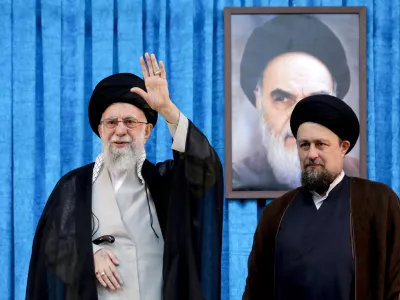 FILE PHOTO: Ayatollah Ruhollah Khomeini's grandson, Hassan Khomeini stands next to Iran's Supreme Leader Ayatollah Ali Khamenei during the 36th anniversary of the death of the leader of Iran's 1979 Islamic Revolution, Ayatollah Ruhollah Khomeini, at Khomeini's shrine in southern Tehran, Iran June 4, 2025. Office of the Iranian Supreme Leader/WANA (West Asia News Agency)/Handout via REUTERS ATTENTION EDITORS - THIS PICTURE WAS PROVIDED BY A THIRD PARTY/File photo