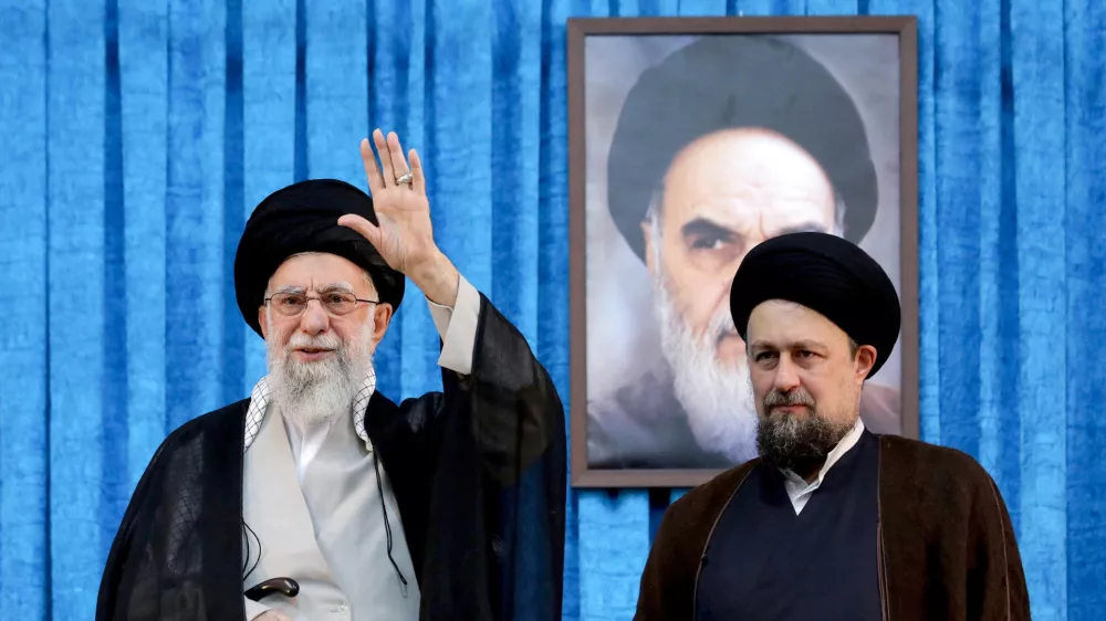 FILE PHOTO: Ayatollah Ruhollah Khomeini's grandson, Hassan Khomeini stands next to Iran's Supreme Leader Ayatollah Ali Khamenei during the 36th anniversary of the death of the leader of Iran's 1979 Islamic Revolution, Ayatollah Ruhollah Khomeini, at Khomeini's shrine in southern Tehran, Iran June 4, 2025. Office of the Iranian Supreme Leader/WANA (West Asia News Agency)/Handout via REUTERS ATTENTION EDITORS - THIS PICTURE WAS PROVIDED BY A THIRD PARTY/File photo