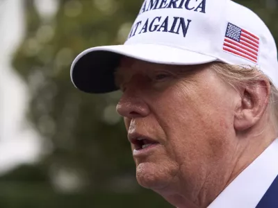 President Donald Trump speaks with reporters as a flag pole is installed on the South Lawn of the White House, Wednesday, June 18, 2025, in Washington. (AP Photo/Evan Vucci)
