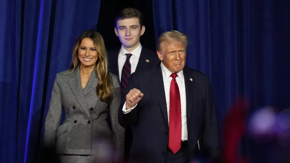 FILE - Republican presidential nominee former President Donald Trump, joined by wife Melania Trump, left, and son Barron Trump, arrives to speak at an election night watch party, Nov. 6, 2024, in West Palm Beach, Fla. (AP Photo/Alex Brandon, File)