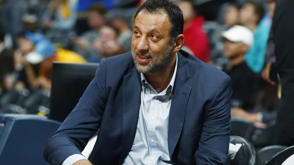 FILE -Sacramento Kings general manager Vlade Divac looks on from the bench as his team warms up before facing the Denver Nuggets in an NBA basketball game, Oct. 21, 2017, in Denver. (AP Photo/David Zalubowski, File)