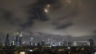 Israeli air defense system fires to intercept missiles during an Iranian attack over Tel Aviv, Israel, Saturday, June 21, 2025. (AP Photo/Leo Correa)
