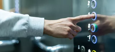 Closeup of person's hand pushing button to select first floor in elevator. Passenger lift. Businessman in office. Movement within building concept
