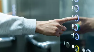 Closeup of person's hand pushing button to select first floor in elevator. Passenger lift. Businessman in office. Movement within building concept