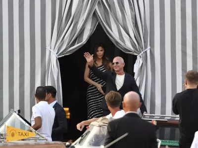 Amazon multi-billionaire founder Jeff Bezos, right, and Lauren Sanchez leave a hotel in Venice, Italy, on Wednesday, June 25, 2025, ahead of festivities in the lagoon city reportedly linked to their wedding. (AP Photo/Luigi Costantini)