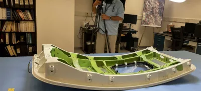 FILE PHOTO: A member of the news media views the Alaska Airlines Flight 1282 door plug in advance of National Transportation Safety Board hearings in early August on the January Alaska Airlines Boeing 737 MAX 9 in-flight door plug emergency, at the NTSB materials lab in Washington, U.S., July 30, 2024. REUTERS/David Shepardson/File Photo