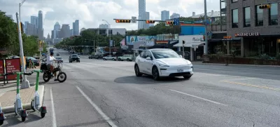 FILE PHOTO: A Tesla robotaxi drives on the street along South Congress Avenue in Austin, Texas, U.S., June 22, 2025. REUTERS/Joel Angel Juarez/File Photo