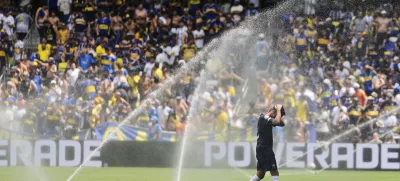 Auckland City's Gerard Garriga cools off under the sprinklers during a water break in the Club World Cup Group C soccer match between Auckland City and Boca Juniors in Nashville, Tenn., Tuesday, June 24, 2025. (AP Photo/George Walker IV)