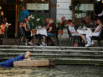 People look at an installation of a mannequin depicting Amazon Founder Jeff Bezos on a "raft" made of Amazon boxes floating in water, as part of a parody stunt by art collective Konn Artiss, ahead of the anticipated wedding of Bezos and journalist Lauren Sanchez in Venice, Italy, June 25, 2025. Click News/Handout via REUTERS  THIS IMAGE HAS BEEN SUPPLIED BY A THIRD PARTY. NO RESALES. NO ARCHIVES. MANDATORY CREDIT.