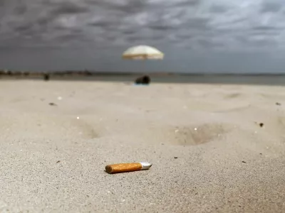 A discarded cigarette butt lies on the sand of La Baule beach on the Atlantic coast, as a nationwide ban on smoking is due to come into effect on July 1, at beaches, parks and outside schools to protect children, France, June 25, 2025. REUTERS/Stephane Mahe