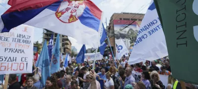 University students and people protest in front of the government building, six months after the deadly train station tragedy that sparked mass demonstrations against corruption, in Belgrade, Serbia, Thursday, May 1, 2025. (AP Photo/Darko Vojinovic)