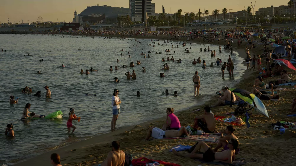 Swimmers cool off in the water at a beach on a hot day in Barcelona, Spain, Sunday, June 29, 2025. (AP Photo/Emilio Morenatti)