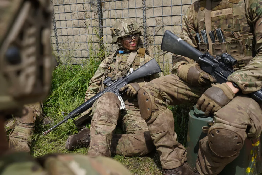 A female conscript sits with members of her unit during final exercises at a training area close to Royal Danish Army's barracks in Hovelte, 25 kilometres north of Copenhagen, Denmark, Wednesday, June 11, 2025. (AP Photo/James Brooks)