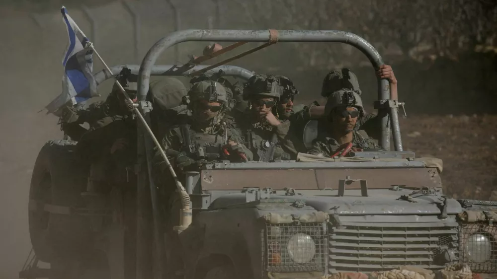 FILE PHOTO: An Israeli military vehicle rides on the Golan Heights side of the ceasefire line with Syria, as seen from Majdal Shams in the Israeli-occupied Golan Heights, December 18, 2024. REUTERS/Shir Torem/File Photo