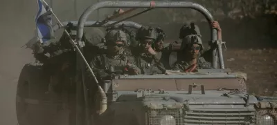 FILE PHOTO: An Israeli military vehicle rides on the Golan Heights side of the ceasefire line with Syria, as seen from Majdal Shams in the Israeli-occupied Golan Heights, December 18, 2024. REUTERS/Shir Torem/File Photo