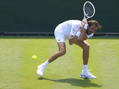 Daniil  Medvedev of Russia returns the ball to Benjamin Bonzi of France during their first round men's single match at the Wimbledon Tennis Championships in London, Monday, June 30, 2025. (AP Photo/Kirsty Wigglesworth)