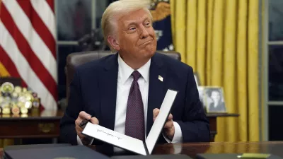 FILE - President Donald Trump signs executive orders in the Oval Office of the White House, Jan. 20, 2025, in Washington. (AP Photo/Evan Vucci, File)