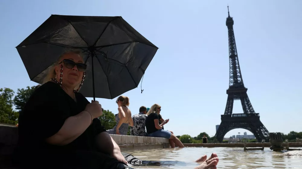 Svetlana from Russia cools off in the Trocadero Fountain next to the Eiffel Tower as an early summer heatwave hits Paris, France, July 1, 2025. REUTERS/Tom Nicholson