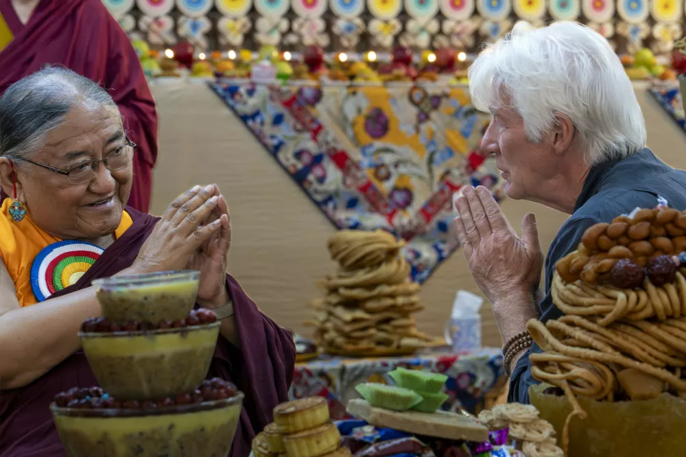 Actor Richard Gere, right, greets Sakya Trizin Ngawang Kunga, a prominent Tibetan Buddhist leader, at an event during which devotees celebrated the 90th birthday of Tibetan spiritual leader the Dalai Lama according to a Tibetan calendar, at the Tsuglakhang temple in Dharamshala, India, Monday, June 30, 2025, ahead of his birthday according to the Gregorian calendar on July 6. (AP Photo/Ashwini Bhatia)