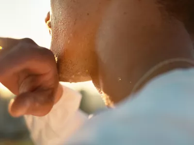 Chin, hand and sweating with sports person outdoor in nature closeup for exercise or fitness. Cardio, challenge and intense with athlete wiping perspiration from skin for marathon training or workout / Foto: Jacob Wackerhausen