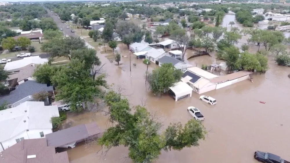 A drone view shows flooded houses, following torrential rains that unleashed flash floods along the Concho River in San Angelo, Texas, U.S., July 4, 2025, in this screen grab obtained from a social media video. Patrick Keely via REUTERS  THIS IMAGE HAS BEEN SUPPLIED BY A THIRD PARTY. MANDATORY CREDIT. NO RESALES. NO ARCHIVES.   TPX IMAGES OF THE DAY   REFILE - CORRECTING NAME OF RIVER FROM "GUADALUPE" TO "CONCHO" AND MONTH FROM "JUNE" TO "JULY