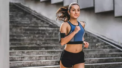 Young caucasian woman runner jogging on the stairs in sporty outfit outdoors / Foto: Inside Creative House