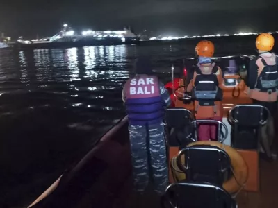 In this photo released by the Indonesian National Search and Rescue Agency (BASARNAS) rescuers search for victims after a ferry enroute for the resort island of Bali sank off Ketapang, East Java, Indonesia, early Thursday, July 3, 2025. (BASARNAS via AP)