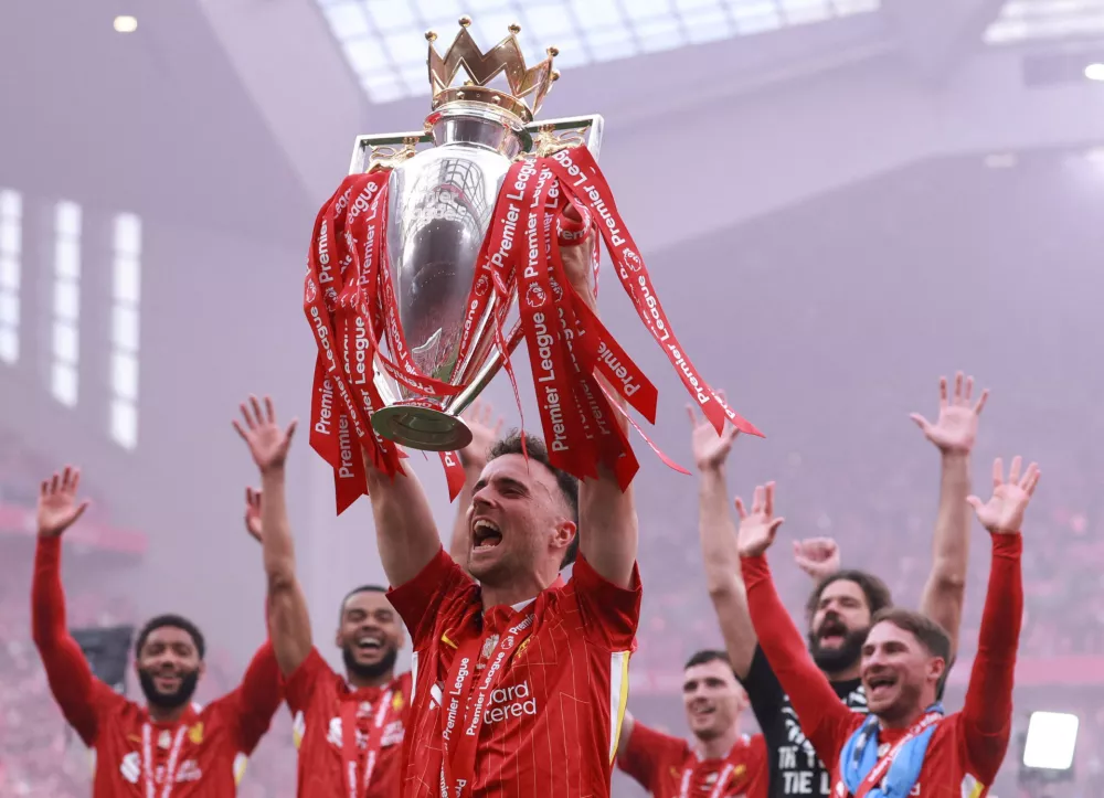 FILE PHOTO: Soccer Football - Premier League - Liverpool v Crystal Palace - Anfield, Liverpool, Britain - May 25, 2025 Liverpool's Diogo Jota celebrates with the trophy after winning the Premier League REUTERS/Phil Noble/File Photo EDITORIAL USE ONLY. NO USE WITH UNAUTHORIZED AUDIO, VIDEO, DATA, FIXTURE LISTS, CLUB/LEAGUE LOGOS OR 'LIVE' SERVICES. ONLINE IN-MATCH USE LIMITED TO 120 IMAGES, NO VIDEO EMULATION. NO USE IN BETTING, GAMES OR SINGLE CLUB/LEAGUE/PLAYER PUBLICATIONS. PLEASE CONTACT YOUR ACCOUNT REPRESENTATIVE FOR FURTHER DETAILS.