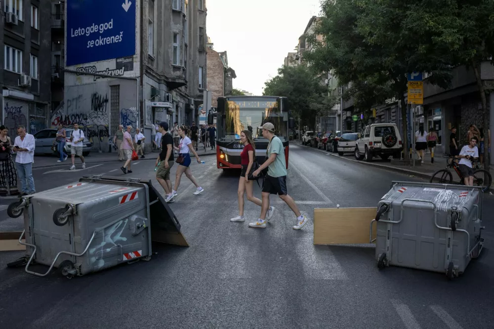 People walk past barricades during road blockades organised by students and anti-government demonstrators demanding snap elections and release of detained protestors, in Belgrade, Serbia, June 30, 2025. REUTERS/Marko Djurica